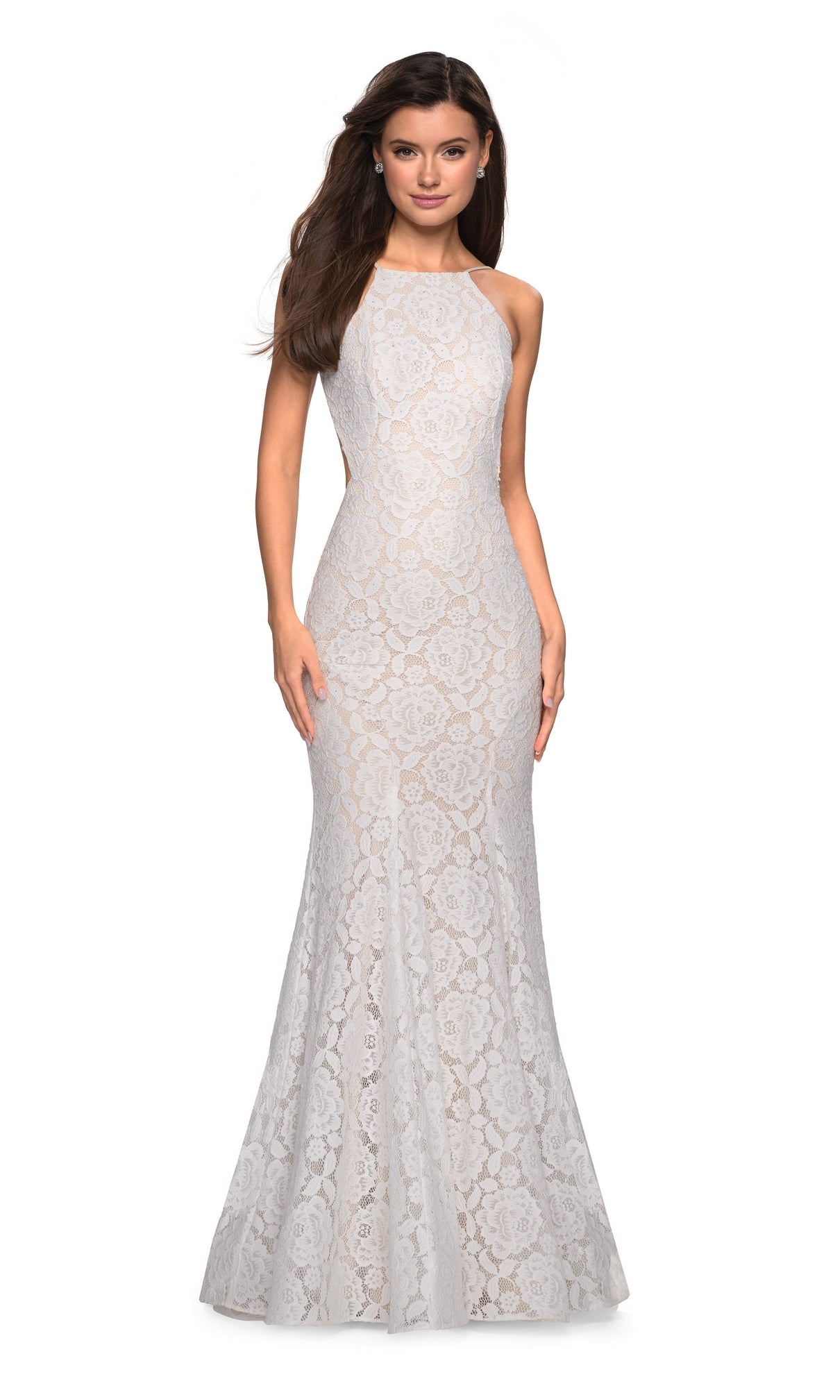 A woman stands against a plain background, wearing the La Femme Floral Lace Mermaid Prom Dress 27289—sleeveless and floor-length with a fitted bodice, high neckline, floral lace design, and slight flare at the hem.